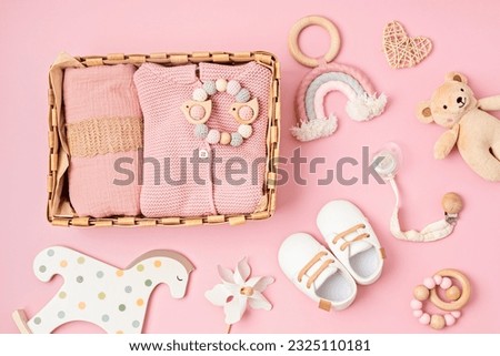 Gift basket with gender neutral baby garment and accessories. Care box of organic newborn clothes, fashion, branding, small business idea. Flat lay, top view Royalty-Free Stock Photo #2325110181