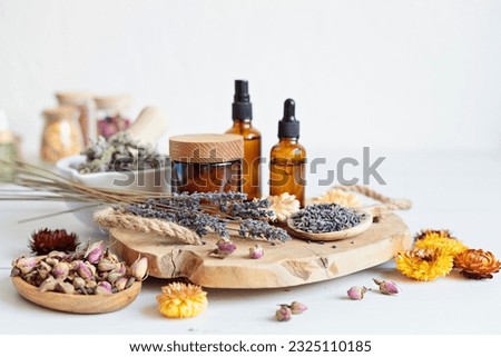 Botanical blends, herbs, essencial oils for naturopathy. Natural remedy, herbal medicine, blends for bath and tea on wooden table background Royalty-Free Stock Photo #2325110185