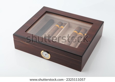 Cigar humidor
Storage container for cigars
Preserves freshness and flavor
Humidity control system
Durable and stylish design
Holds multiple cigars
Protects against moisture and temperature changes
Inc Royalty-Free Stock Photo #2325111057