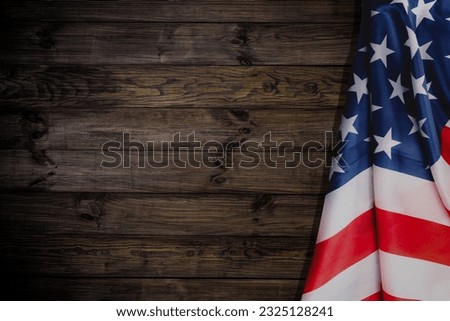 American flag on brown wooden background. USA star-spangled banner. Memorial Day. 4th of July. Independence day. Veterans day. Waving flag design for poster, flyer, greeting card, invitation.