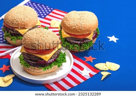 Homemade burgers. An American classic, traditional food for picnic, party or celebration Independence Day. Hard light, dark shadow, flat lay, blue background, close up