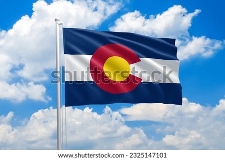 Colorado flag waving in the wind on clouds sky. High quality fabric. International relations concept Royalty-Free Stock Photo #2325147101