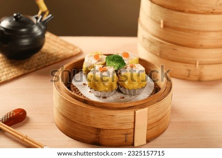 yumcha, dim sum,Hong Kong steamed siew mai meatball dumpling with wanton skin and roe in bamboo basket asian dim sum menu Royalty-Free Stock Photo #2325157715