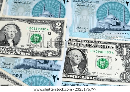 Background of USD American dollars money bills with the new Egyptian 20 EGP LE twenty polymer pounds cash money banknote bill features Mohamed Ali Mosque, American and Egyptian currency exchange rate