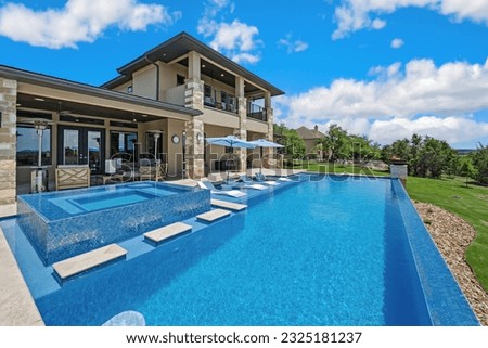 a luxury modern pool with an infinity edge Royalty-Free Stock Photo #2325181237