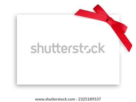 White card with red bow on the right top corner. Template for invitation, birthday or party. Selective focus. 