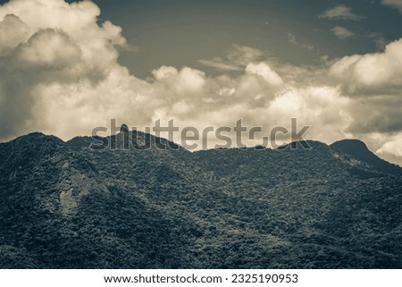 Old black and white picture of Abraao mountain Pico do Papagaio with clouds on Ilha Grande Angra dos Reis Rio de Janeiro Brazil.