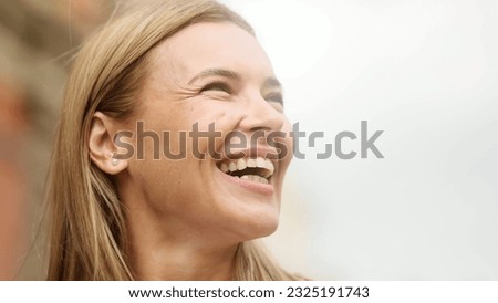 Close up portrait of smiling carefree mature blond woman feeling absolutely happy and satisfied enjoying great day at city street Self confidence female looking ahead feel proud achievement alone
