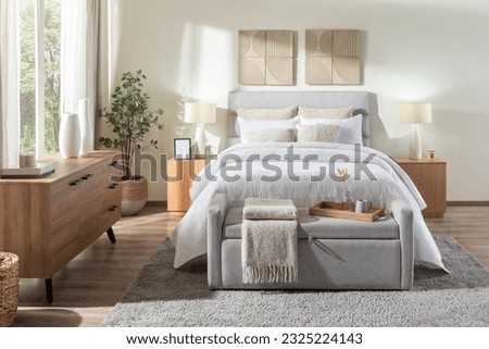 An interior bedroom scene featuring a bed, stool, and dressers Royalty-Free Stock Photo #2325224143