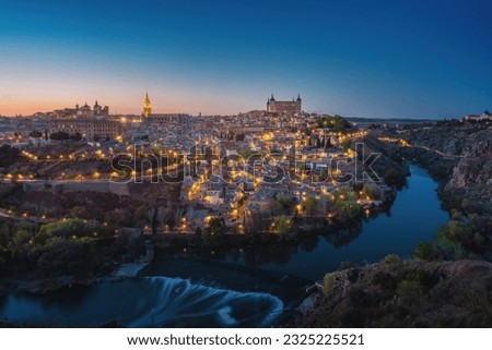 Toledo Skyline with Cathedral, Alcazar and Tagus River at night - Toledo, Spain