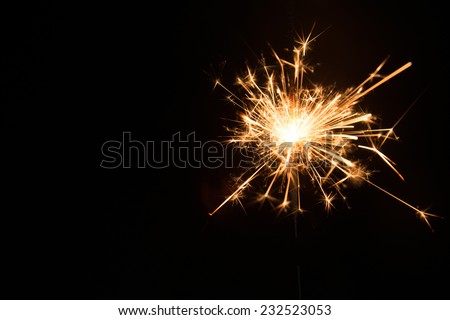 New year party sparkler on black background Royalty-Free Stock Photo #232523053