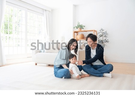 Smiling Asian family at home Royalty-Free Stock Photo #2325236131