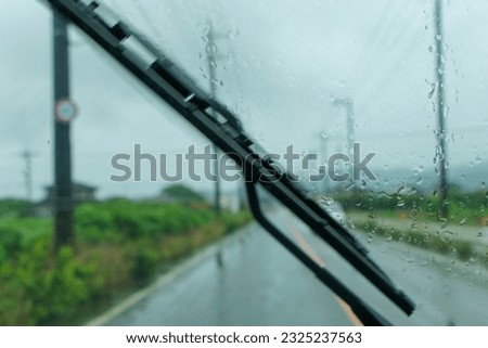 Raindrops on the windshield on a rainy day