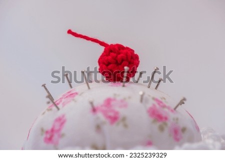details of a cupcake-shaped pincushion, on a white background