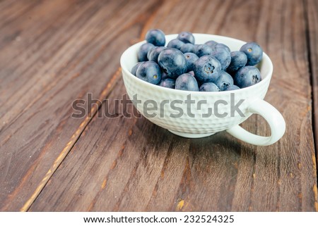 Blueberry cup on wooden background - vintage effect style pictures