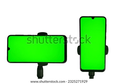 tripod with smartphone horizontal and vertical position, green screen screen. isolated white background