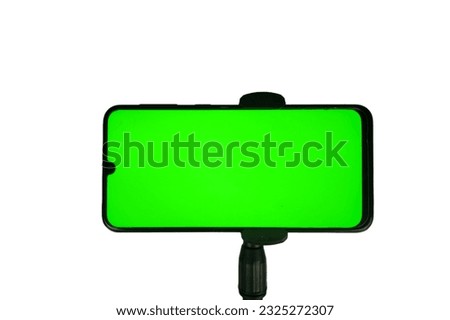 tripod with smartphone horizontal position, green screen screen. isolated white background