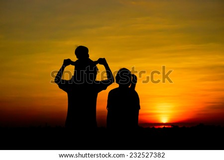 Silhouette of a family comprising a father, mother, and a child Royalty-Free Stock Photo #232527382