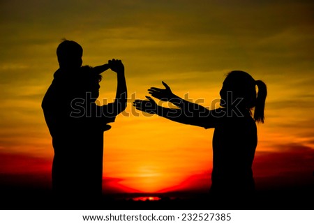Silhouette of a family comprising a father, mother, and a child Royalty-Free Stock Photo #232527385