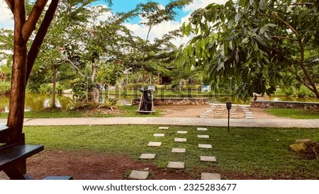 the garden has stone floors that are checkered for footprints so as not to step on the grass directly aiming not to damage it, the garden has several trees so that the garden looks beautiful