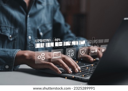 Businessman working and installing update process. Software updates or operating system upgrades to keep your device up to date with enhanced functionality in new versions and improved security. Royalty-Free Stock Photo #2325289991