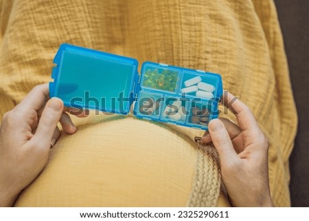 Prenatal Vitamins. Portrait Of Beautiful Smiling Pregnant Woman Holding Pill Box, Taking Supplements For Healthy Pregnancy While Sitting On Couch At Home, Free Space Royalty-Free Stock Photo #2325290611