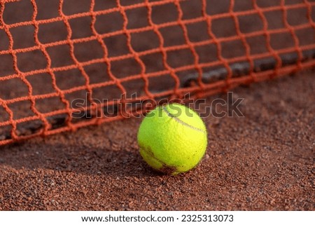tennis court with a dirt surface and a yellow ball sports background