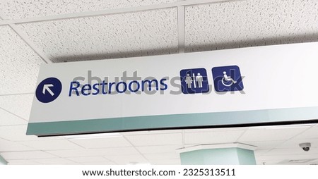 restroom sign depicting gender icons of a woman and a man, symbolizing social issues surrounding gender identity and inclusivity