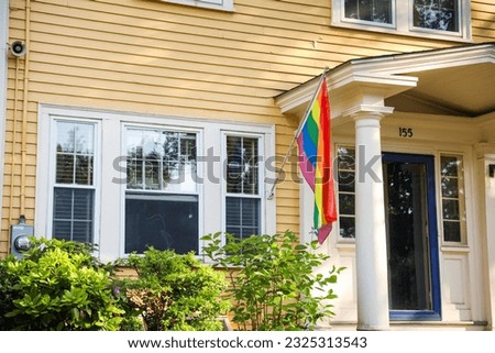 Vibrant gay pride rainbow flag intertwines with Juneteenth symbolism, celebrating freedom, equality, and diversity in a powerful fusion