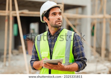 Portrait of cvil engineer with safety uniform working at construction site outdoor, Construction worker checking and controlling project on building site, Architecture engineering on new project Royalty-Free Stock Photo #2325331811