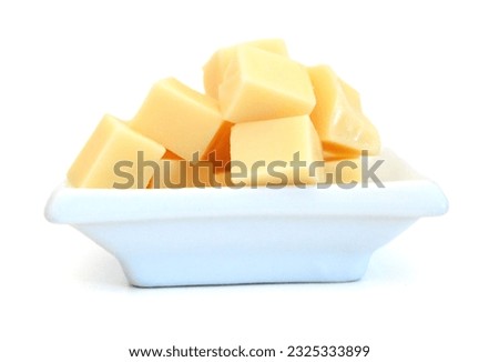 Cubes of cheddar cheese isolated on white  Royalty-Free Stock Photo #2325333899