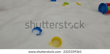 white sand children's play area with children's toys