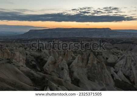 A picture of the landscape of the Goreme Historical National Park, as seen from Love Valley, at sunrise.