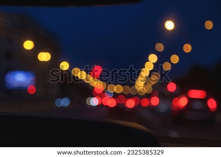Car windshield view on New York night highway with car and street lamps. Defocused lights cityscape, style color tone. Abstract stylish urban backgrounds for design concept. Copy ad text space, banner