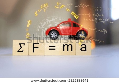 Sir Isaac Newton's equation of motion, force equal to mass times acceleration, or F equal to m multipleply by a on a model car and a wooden cube. Royalty-Free Stock Photo #2325388641