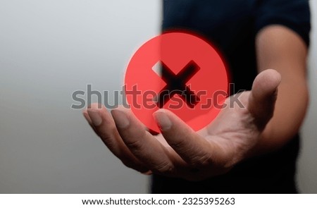 Hand holding red circle icon with cross, cancel symbol, cancel icon, round X sign, cancel button, cross sign, reject, on black background, banner, copy space, paste for text