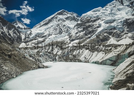 beautiful white frozen lake surrounded by mountains in Everest Region - Nepal