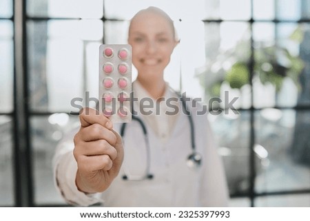 Close up portrait female doctor scientist pharmacist looking at camera presenting new effective pill medicine.