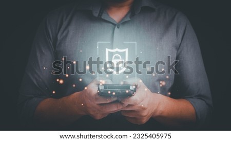 Business man typing on mobile phone with shield and lock icon. Security protection on smartphone application, mobile banking application concept. Royalty-Free Stock Photo #2325405975