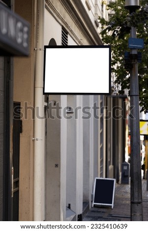 Blank sign fixed to building wall with copy space. Signage, writing space and street signs concept.