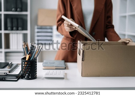 Businesswoman packing up in office, job promotion concept. Royalty-Free Stock Photo #2325412781