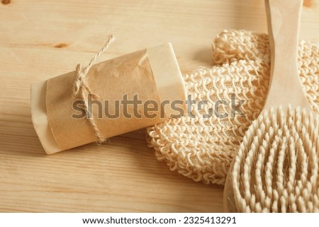 eco set for self-care, soap, washcloth and massage brush wooden background