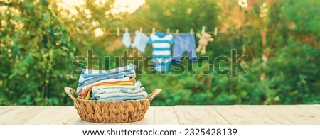 washing baby clothes. Linen dries in the fresh air. Selective focus. nature. Royalty-Free Stock Photo #2325428139