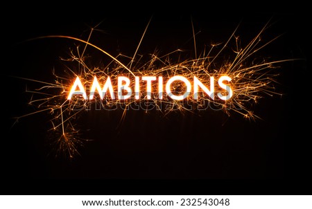 Glowing sparkly Ambitions word on black background with copy space.