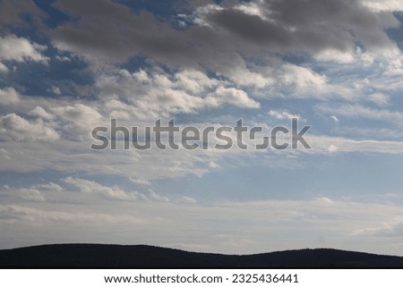 photograph of white dark cirrocumulus clouds in the sky. as the sun sets in the evening. in a sad, rainy, gloomy weather situation. perfect cloudy sky view both bright and dark.

