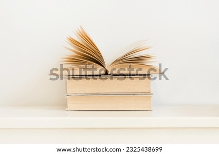 open book on stack of vintage hardback books on table. concept of education, reading, back to school Royalty-Free Stock Photo #2325438699