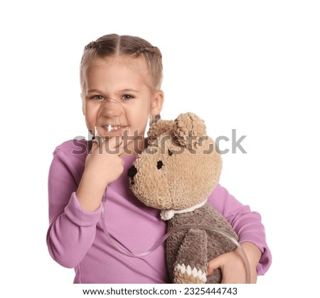 Little girl with toy bear using nebulizer for inhalation on white background Royalty-Free Stock Photo #2325444743