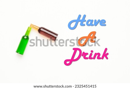 A flatlay picture of two glass bottle miniature with have a drink word.