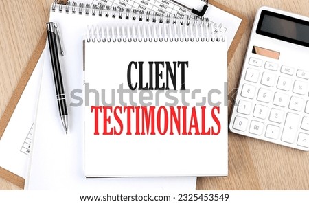 CLIENT TESTIMONIALS is written in white notepad near calculator, clipboard and pen. Business concept Royalty-Free Stock Photo #2325453549