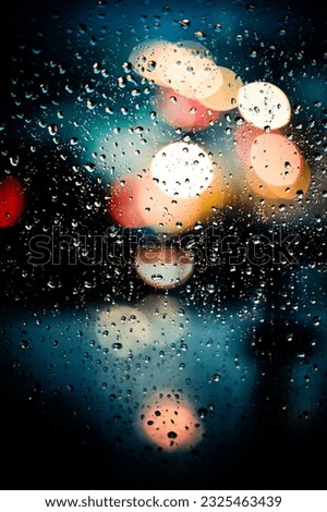 Window with raindrops and bokeh